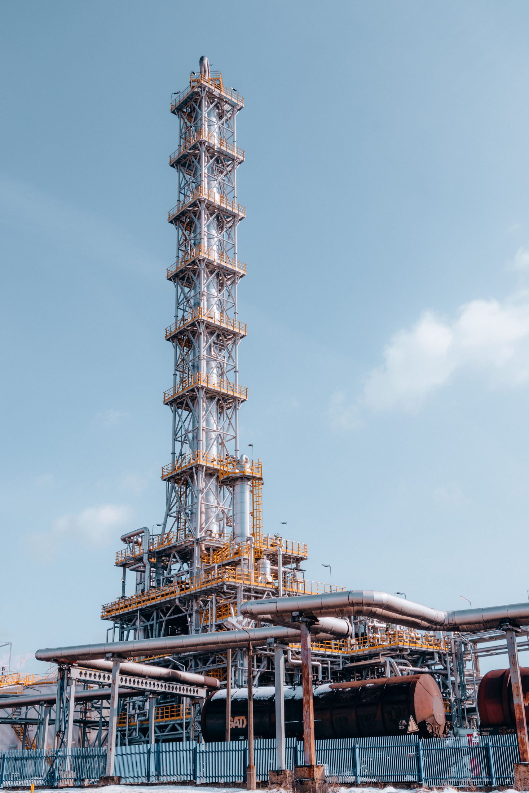 A towering industrial refinery structure in Trzebinia, Lesser Poland Voivodeship.